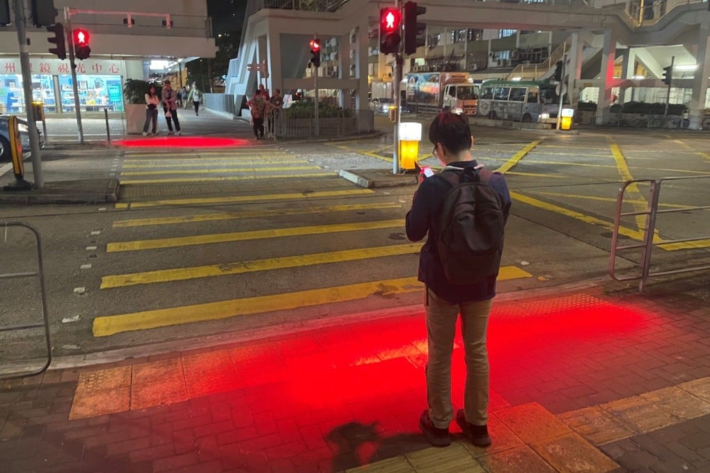 Red lights shine on the ground in Hong Kong to warn smartphone-using pedestrians about traffic signals. Smartphone addiction causes multiple problems, and we should all reduce our use of the gadgets, a psychologist says. Photo: Hong Kong Transport Department