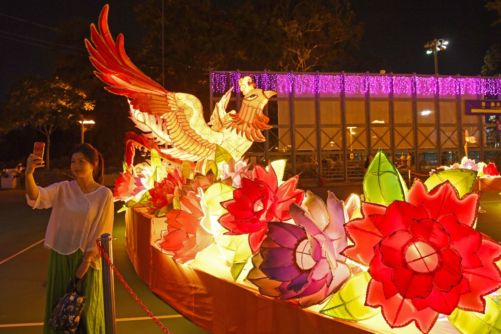 A woman takes selfies at a lantern fair marking the Mid-Autumn Festival and National Day at Victoria Park on September 12. Photo: Xinhua