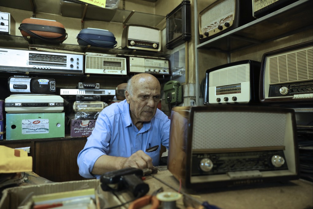 Reza Alimirzaei, 73, who repairs and sells old radios, in his shop in Tehran, Iran. A US radio programme has recently returned to Tehran airwaves  after 45 years. Photo: AP