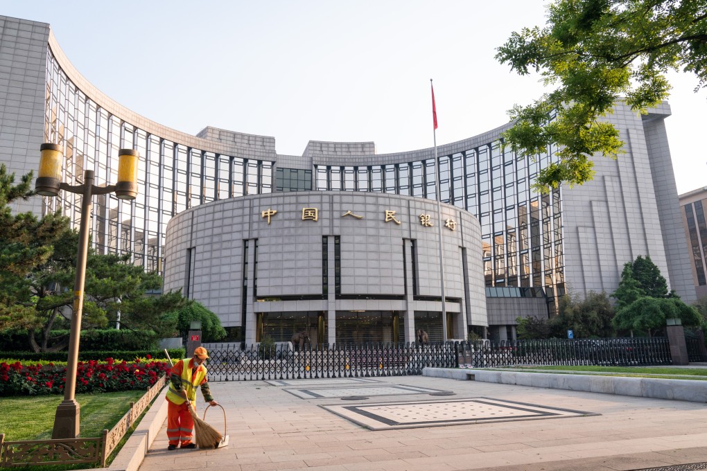 A cleaner sweeps the grounds in front of the People’s Bank of China headquarters in Beijing. Photo: Bloomberg