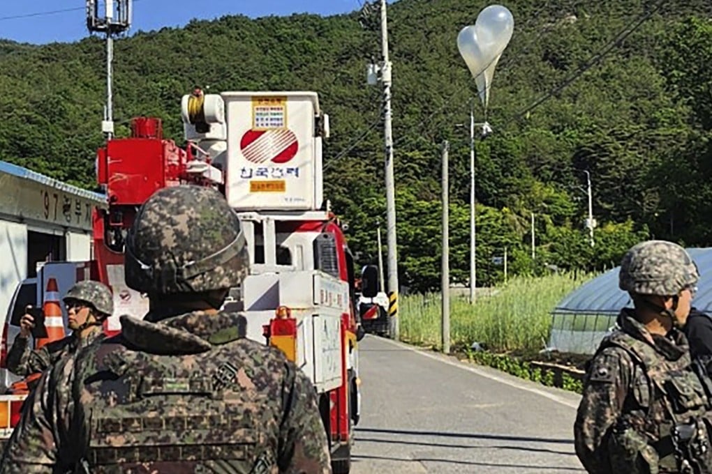 South Korean soldiers stand guard near a balloon presumably sent by North Korea in Muju in May. Photo: Jeonbuk Fire Headquarters via AP