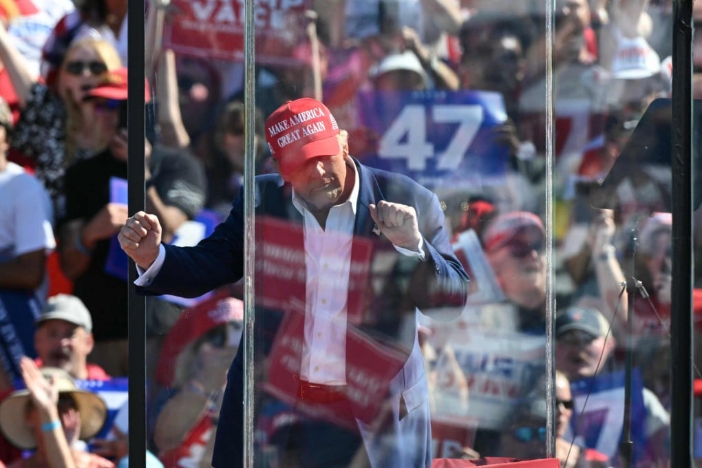 Donald Trump dances behind bulletproof glass at a campaign rally in Wilmington, North Carolina. Photo: AFP