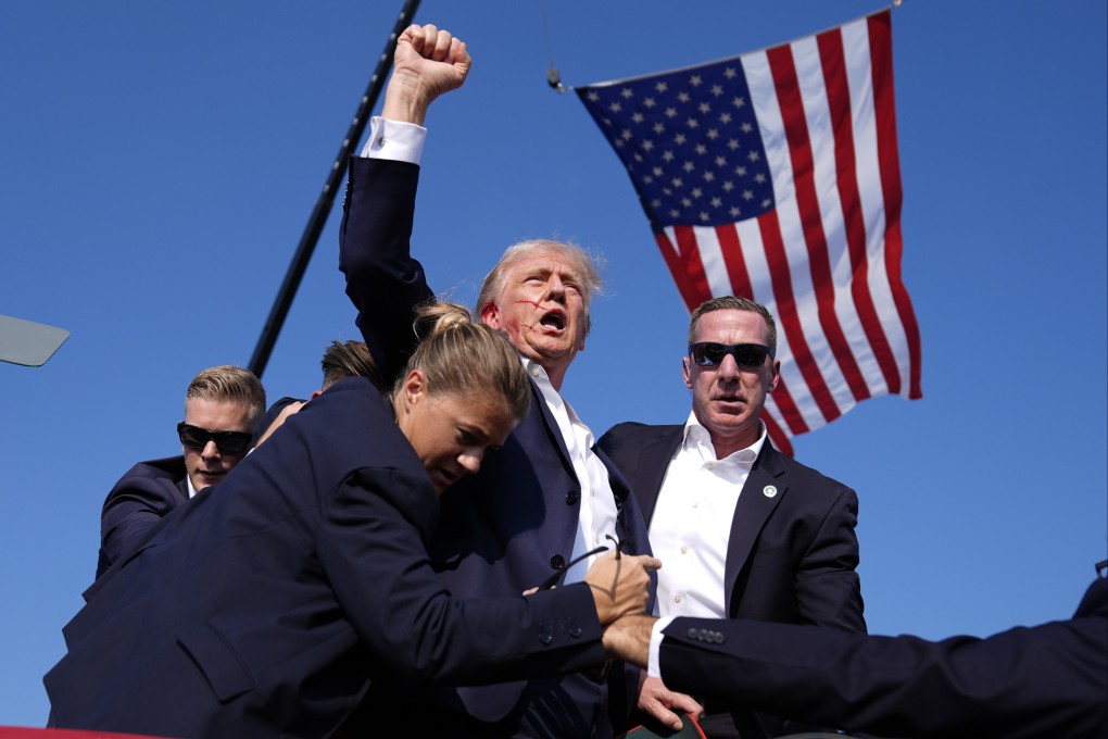 Donald Trump is surrounded by Secret Service agents at a campaign rally in Butler, after he is shot at. Photo: AP