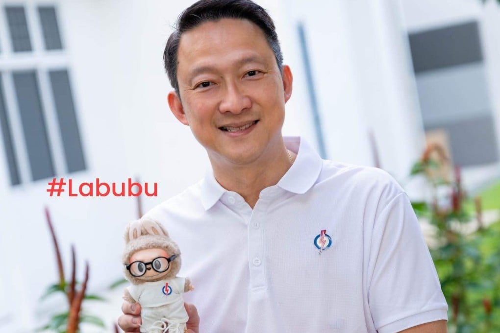 Singapore’s People’s Action Party politician Lam Pin Min with the Labubu doll dressed in PAP colours during a grocery distribution event in Sengkang on Sunday. Photo: Facebook/LamPinMin