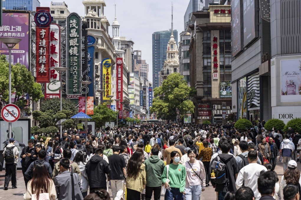 Crowds are seen in the Nanjing Road shopping district of Shanghai. Consumption vouchers will be made available in the city in the coming days to spur consumption. Photo: Bloomberg