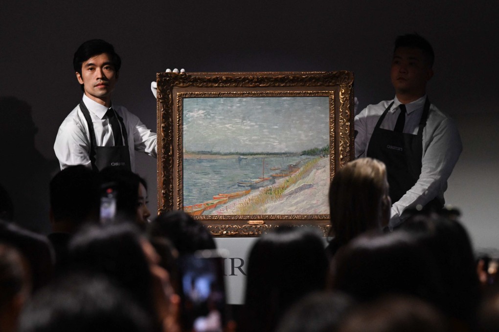 Auction staff hold up painting Les canots amarrés by Vincent Van Gogh, which sold at auction at Christie’s Hong Kong headquarters for HK$215 million (US$27.6 million) on September 26, 2024. Photo: AFP
