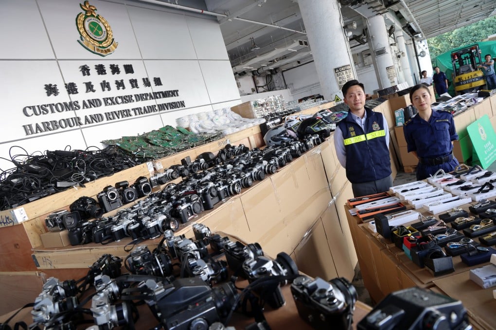 Customs officers showcase smuggled goods seized by the department earlier this month. Photo: Jelly Tse