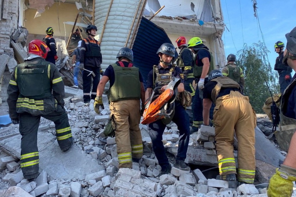 Rescuers work at the site of a Russian missile strike in Kryvyi Rih, Ukraine, on Friday. Amid the war, an American pensioner has been in court, accused of fighting for Ukraine. Photo: Handout via Reuters