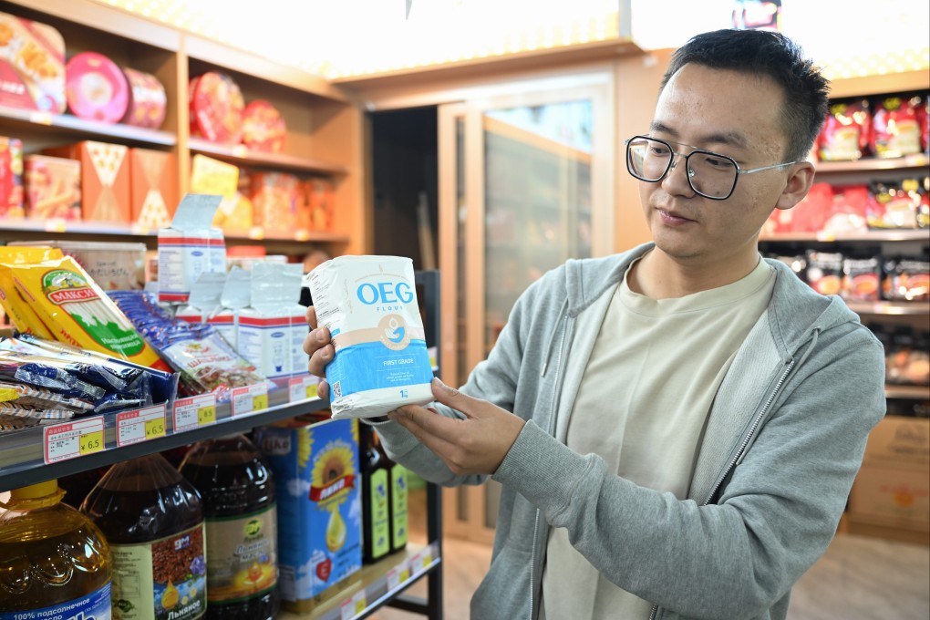 A shop owner displays a Mongolian flour product at an import supermarket in Erenhot, north China’s Inner Mongolia autonomous region. Photo: Xinhua