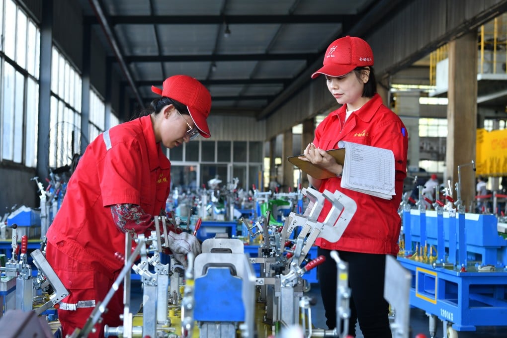 Workers check product quality at a molding plant in China’s Hebei province on Tuesday. Industrial profits across the country dropped by nearly 18 per cent in August. Photo: Xinhua