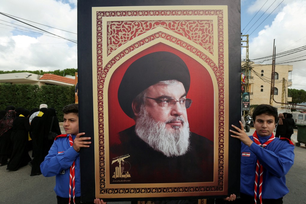 Boy scouts carry a picture of Hezbollah leader Hassan Nasrallah in Kfar Melki, Lebanon, on September 19. Photo: Reuters