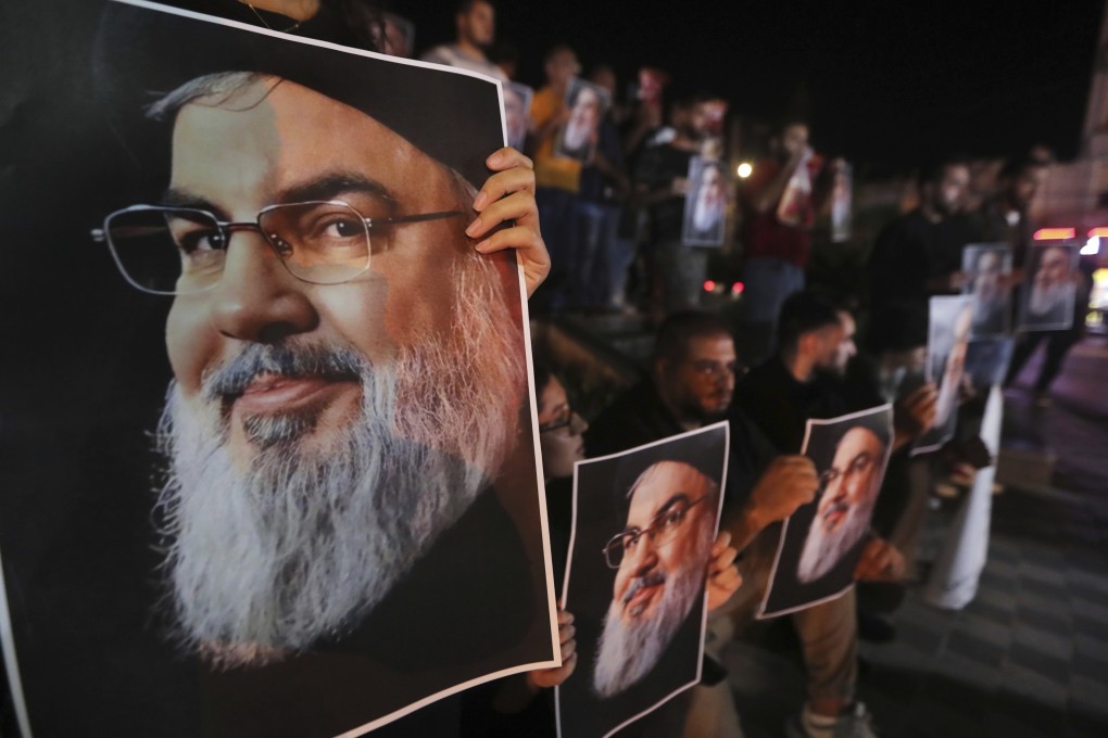 Protesters hold portraits of Hezbollah leader Sayyed Hassan Nasrallah in the southern port city of Sidon, Lebanon, on Saturday. Photo: AP
