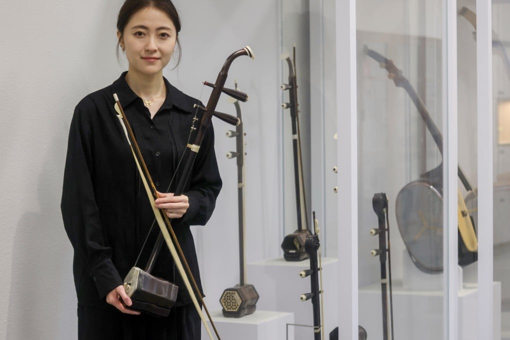 Hong Kong Chinese Orchestra erhu player Song Hui with her instrument. Often compared to the violin, it is a relative newcomer compared to another stringed instrument, the Chinese zither, or guqin. Photo: Jonathan Wong