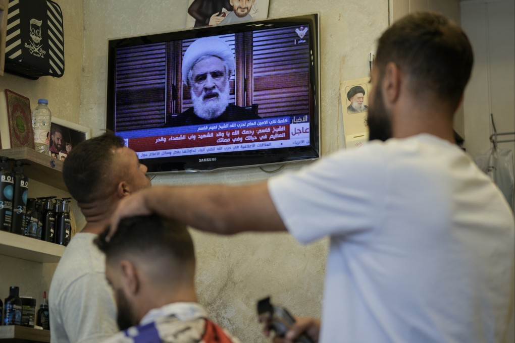 People listen to a speech by Hezbollah’s deputy leader Naim Kassem at a barber’s shop in Beirut, Lebanon, on Monday. Photo: AP