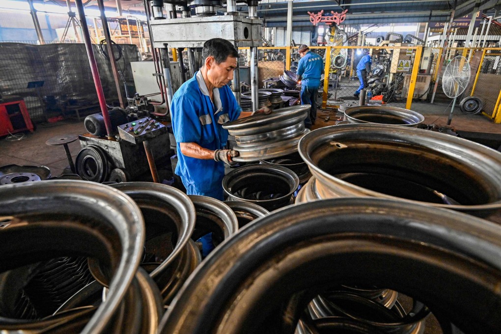 An employee works on a steel wheel production line at a factory in Qingzhou, in eastern China’s Shandong province. Photo: AFP