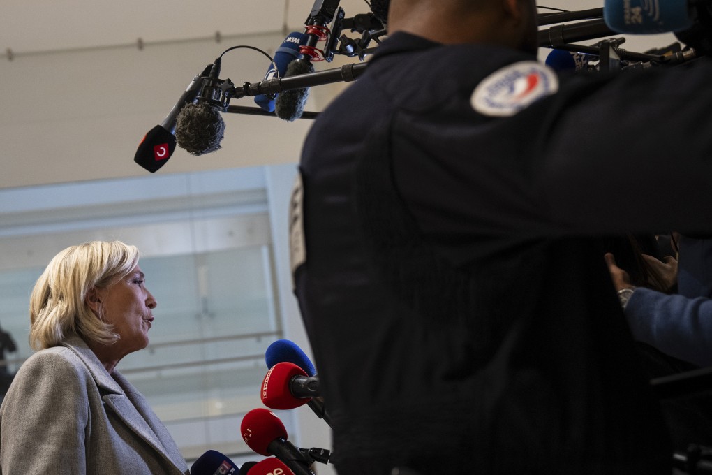 French far-right leader Marine Le Pen speaks to the media as she arrives at court in Paris on Monday. Photo: AP