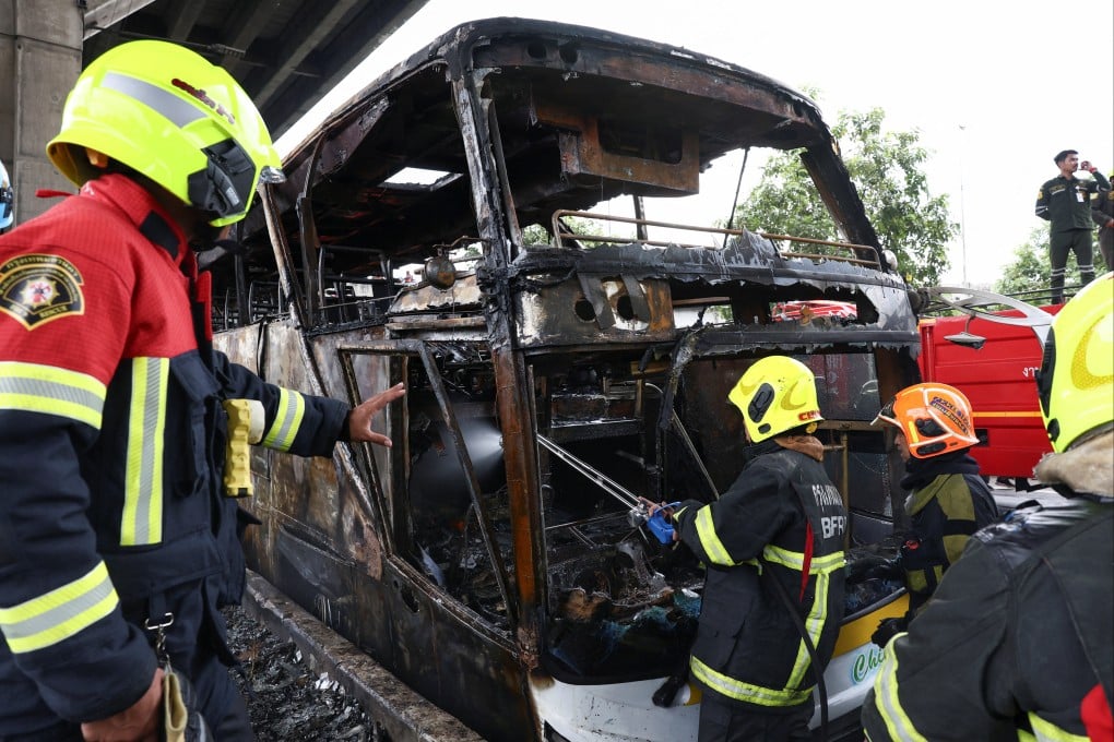 Firefighters work to extinguish a burning bus that was carrying teachers and students from Wat Khao Phraya school on the outskirts of Bangkok, Thailand, on Tuesday. Photo: Reuters