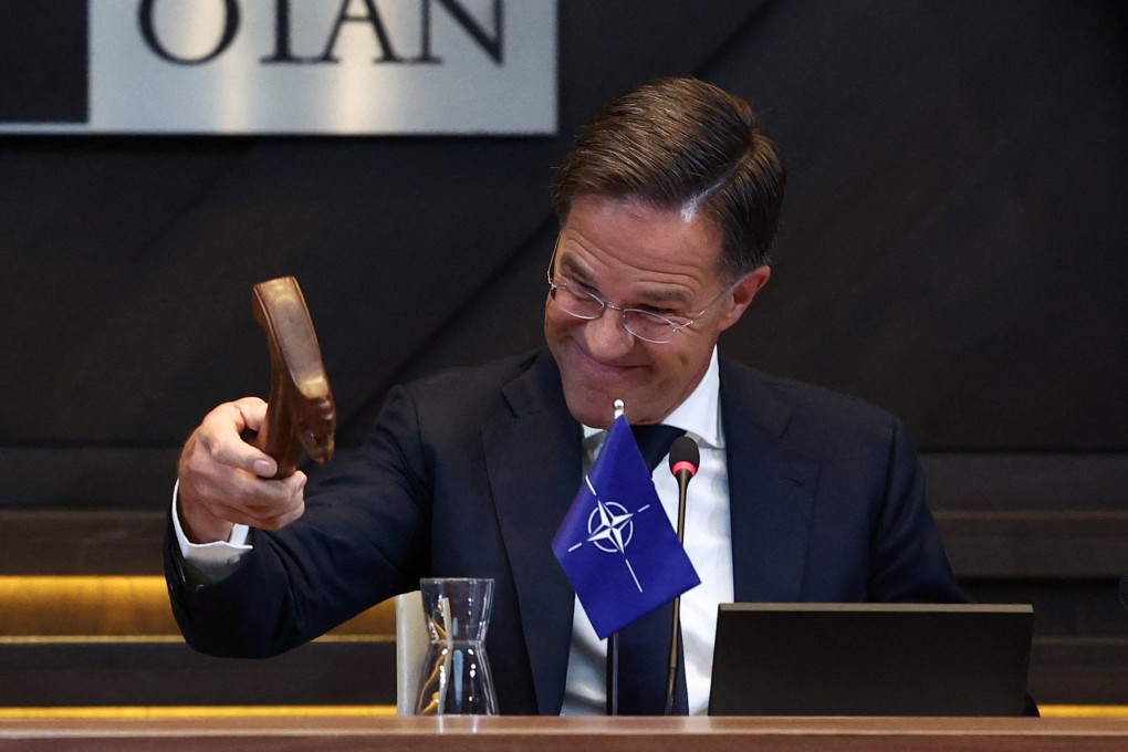 New Nato Secretary General Mark Rutte uses a hammer at a meeting of the North Atlantic Council in Brussels. Photo: Reuters
