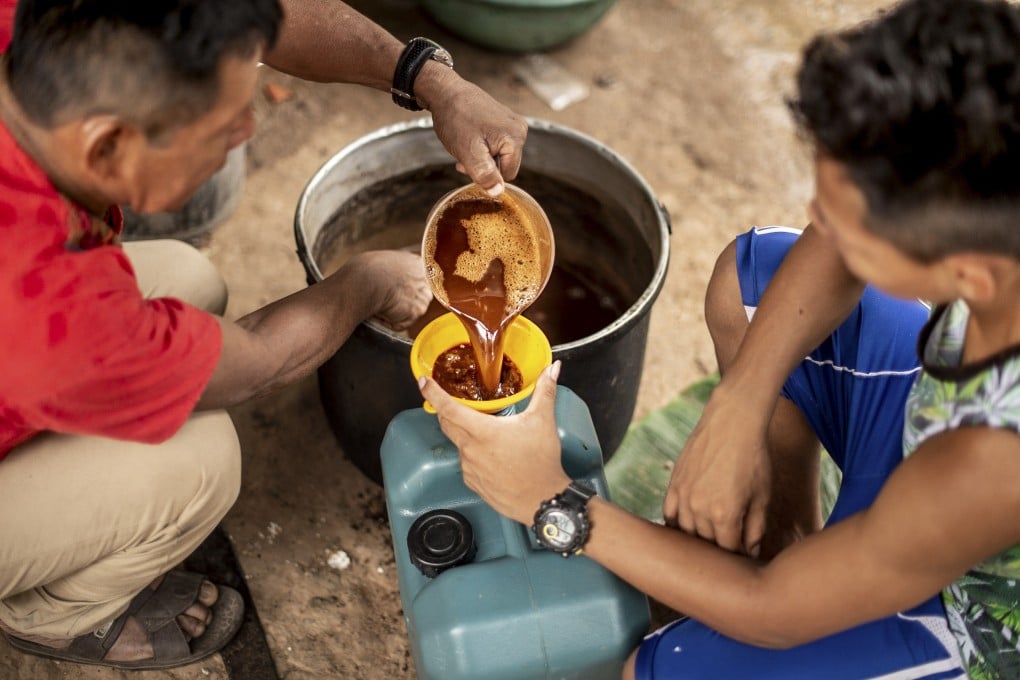 A shaman in Peru puts a broth of ayahuasca into a cup. Photo: Getty Images