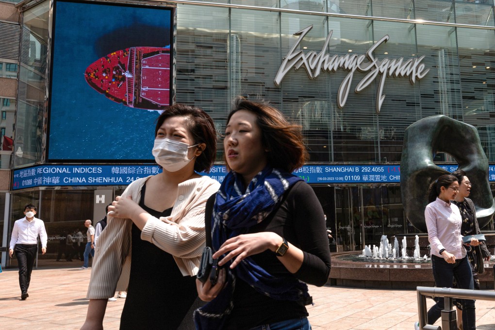 Pedestrians walk past a stock ticker outside the Exchange Square in Central. Photo: EPA-EFE