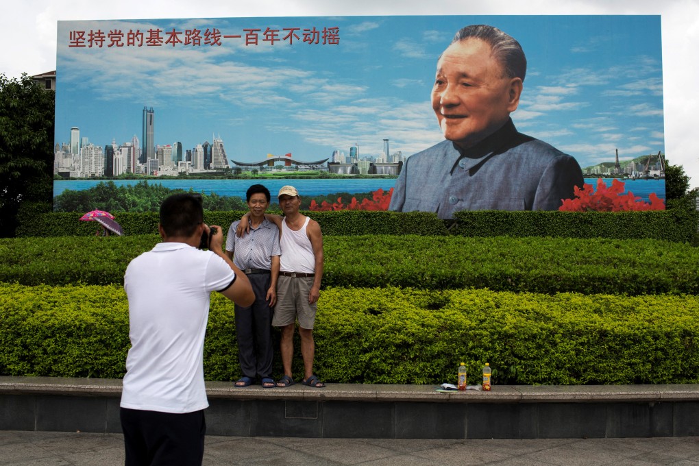 People in Shenzhen pose for a picture in front of a picture of the late Chinese paramount leader Deng Xiaoping, who called for a “bold and steady” approach to reforms. Photo: Reuters