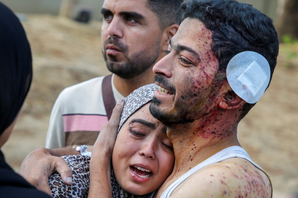 A Palestinian man who was wounded in an Israeli strike that killed his relatives, embraces his niece who was injured along with him, in Khan Younis in the southern Gaza Strip. Photo: Reuters