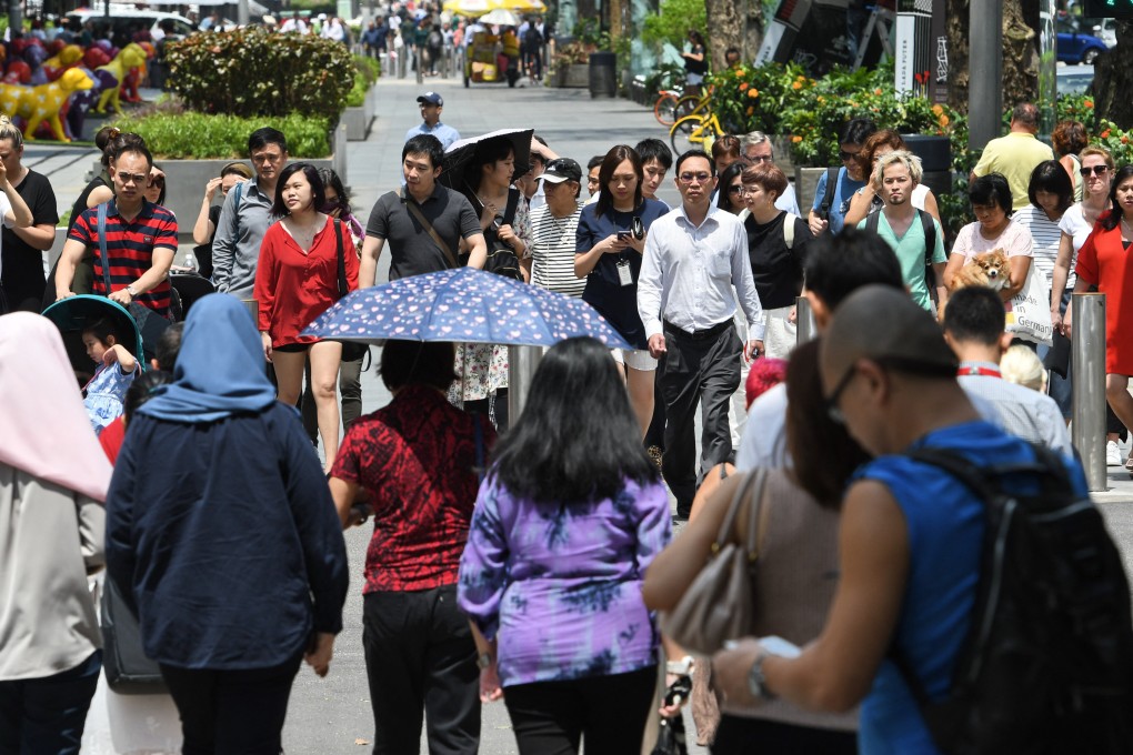 Pedestrians in the Orchard Road shopping district in Singapore in 2018. Chinese names were once pronounced according to a person’s local dialect. This is dying out. Photo: AFP