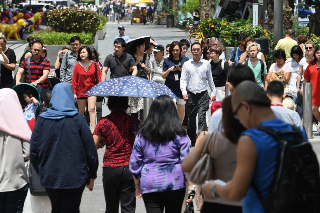 Pedestrians in the Orchard Road shopping district in Singapore in 2018. Chinese names were once pronounced according to a person’s local dialect. This is dying out. Photo: AFP