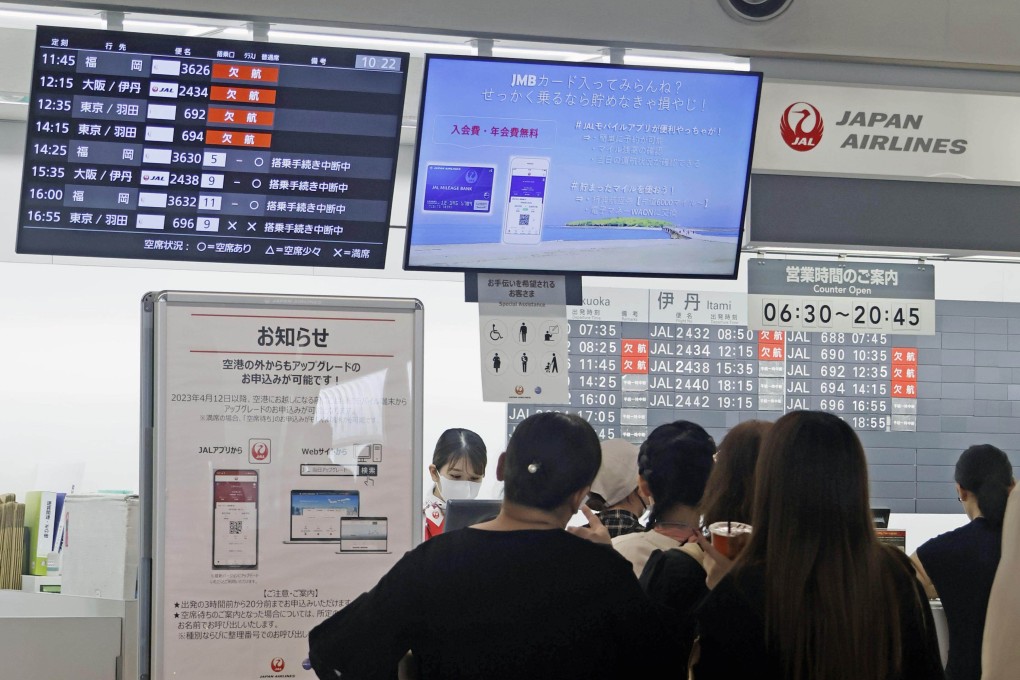 Passengers wait at a Japan Airlines counter at Miyazaki airport following the closure of the runway that grounded 87 flights. Photo: Kyodo