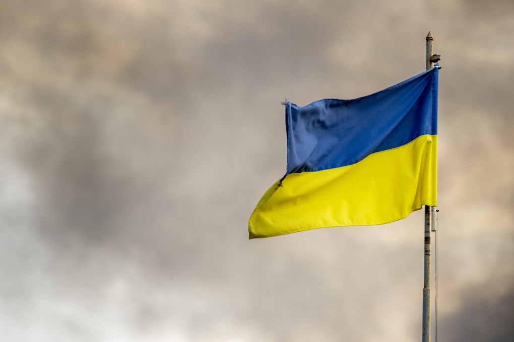 A Ukrainian flag is seen in front of thick smoke in Kyiv after Russian missile attacks in September. Photo: dpa