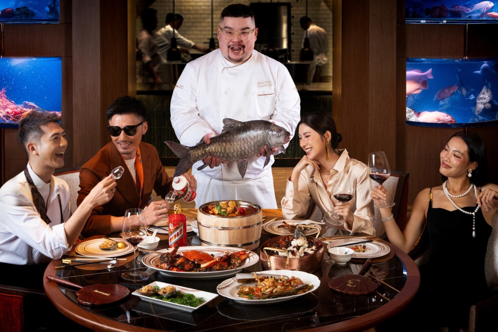 Drunken Fish executive chef Henry Zhang Zhicheng (centre) holds a fish at the restaurant in Macau, one of nine new places we recommend checking out in Hong Kong and Macau this October. Photo: Wynn Macau