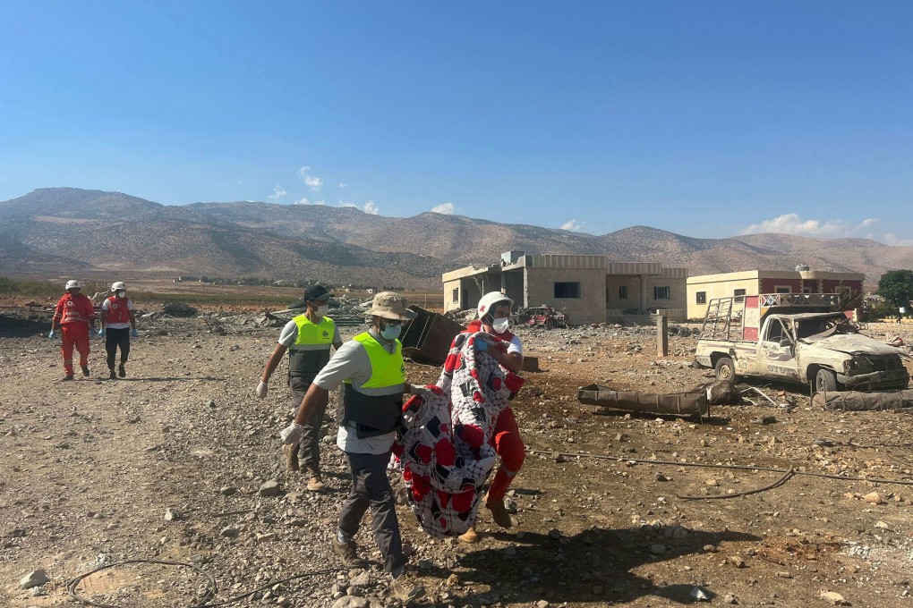 Paramedics recover a body from the site of an Israeli strike on the eastern Lebanese village of Zabboud in the Bekaa valley on Sunday. Photo: AFP