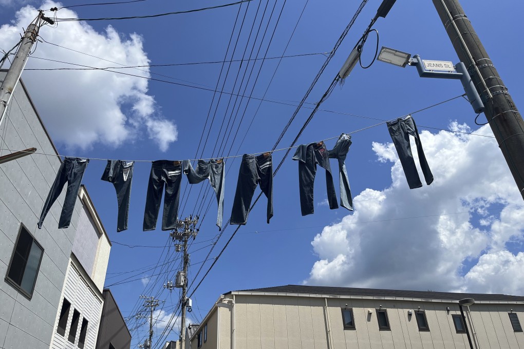 Jeans hang over Jeans Street in Kojima. The quiet town in western Japan is known for its sustainably produced Japan Blue jeans, which can sell for US$1,400 a pair. Its attention to craftsmanship has drawn luxury brands like Gucci. Photo: AP