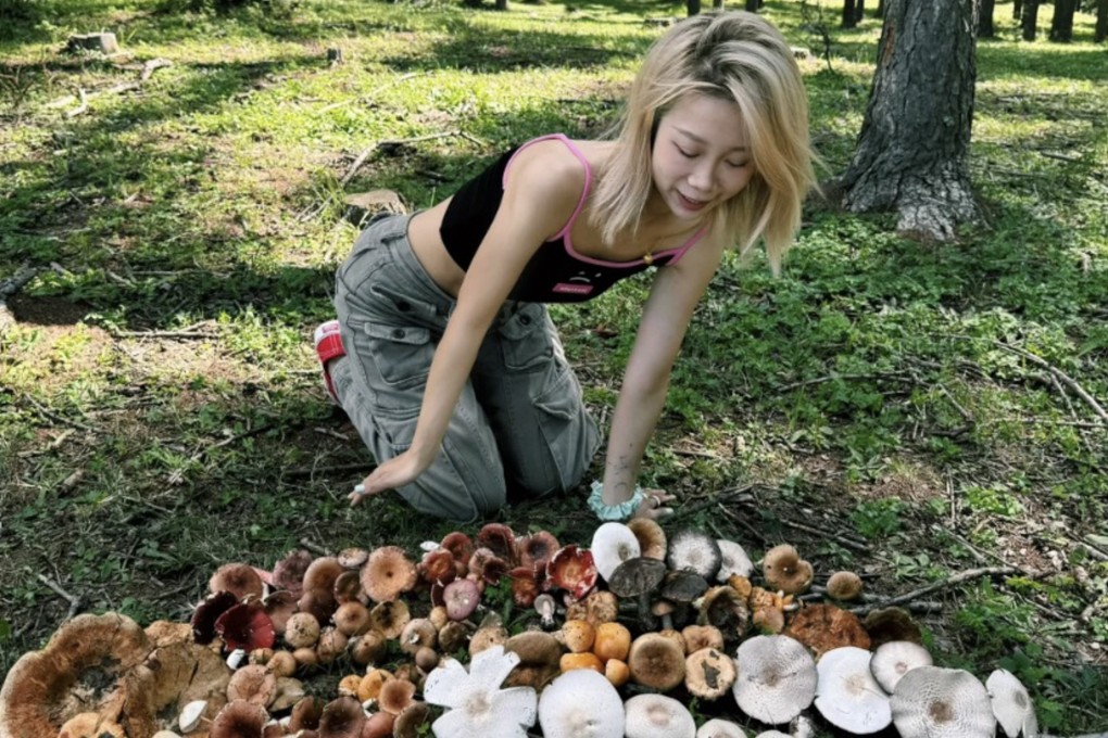 A woman poses with her mushroom collection in a forest near Beijing. Mushroom foraging has become a new viral hobby in China. Photo: Xiaohongshu