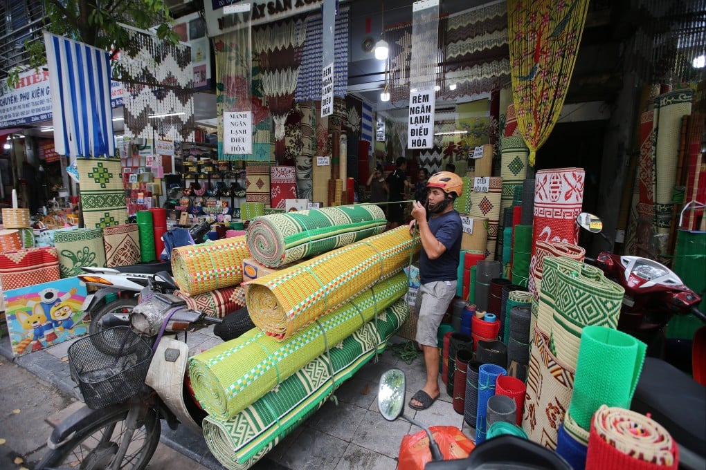 A man loads mats onto a motorbike in Hanoi, Vietnam. Photo: EPA-EFE
