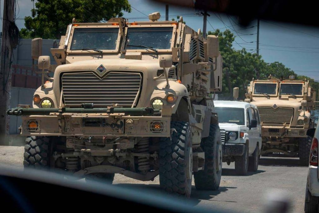 Armoured vehicles used by Kenyan police rumble through the streets of Port-au-Prince, Haiti. Photo: TNS