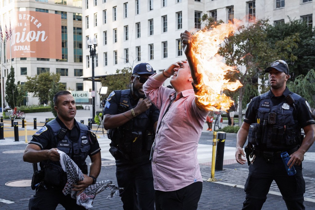 Police help a man who tried to set himself on fire as people demonstrate to mark one year of the war between Hamas and Israel near the White House. Photo: AFP