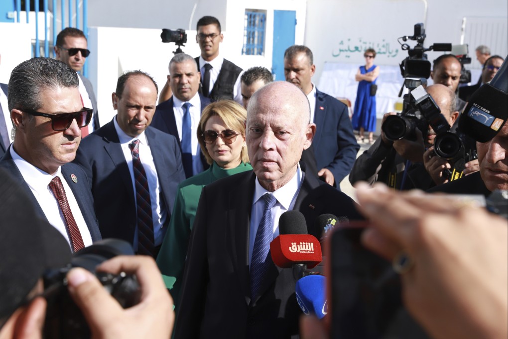 Tunisian President and candidate for re-election Kais Saied, center, and his wife Ichraf Chebil Saïed, leave a polling station after casting their votes, in Tunis, Tunisia, on Sunday. Photo: AP