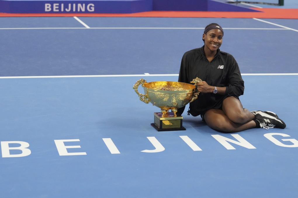 Coco Gauff celebrates with the trophy after defeating Karolina Muchova in Beijing. Photo: AP