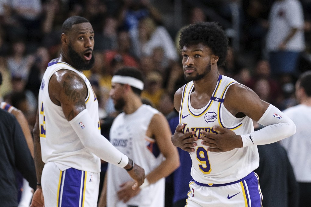 Los Angeles Lakers guard Bronny James (right) steps onto the court with Lakers forward LeBron James during the preseason NBA game against the Phoenix Suns. Photo: AP