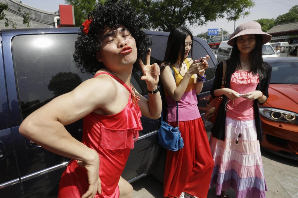 A man wearing a red dress poses for a photo before a hash event in Beijing in 2013. One of the accused said in his defence that it was not unusual for men to wear women’s clothing during hash events. Photo: Reuters