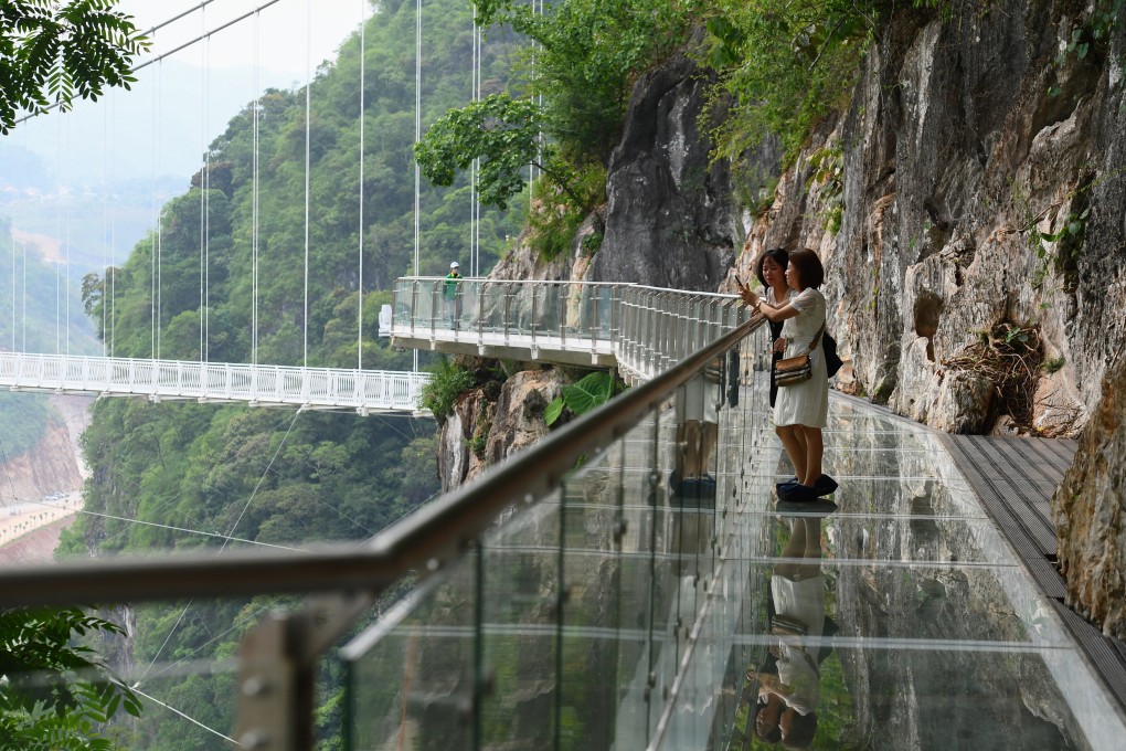 Visitors stand on the walkway section of the Bach Long glass bridge in Vietnam’s Son La province in April 2022. Vietnam is stepping up efforts to improve its soft power through increased tourism and making itself a destination for filmmakers. Photo: AFP