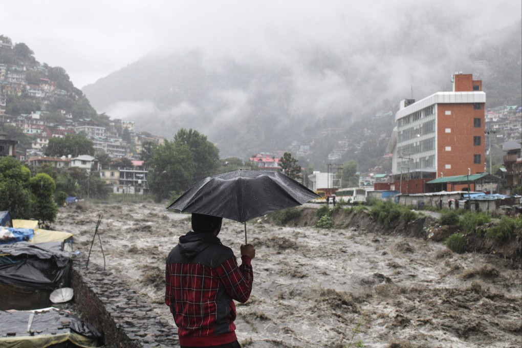 A man looks at a swollen River Beas following heavy rains in Kullu, Himachal Pradesh, India, last year. Photo: AP