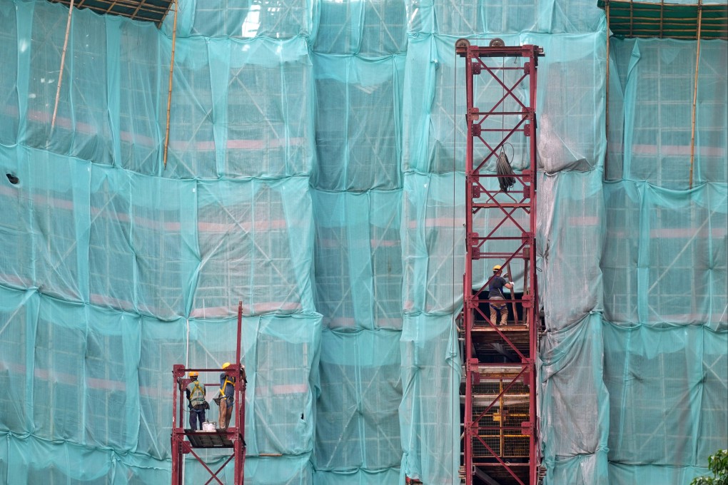 Construction workers on a residential site in North Point. Photo: Elson Li
