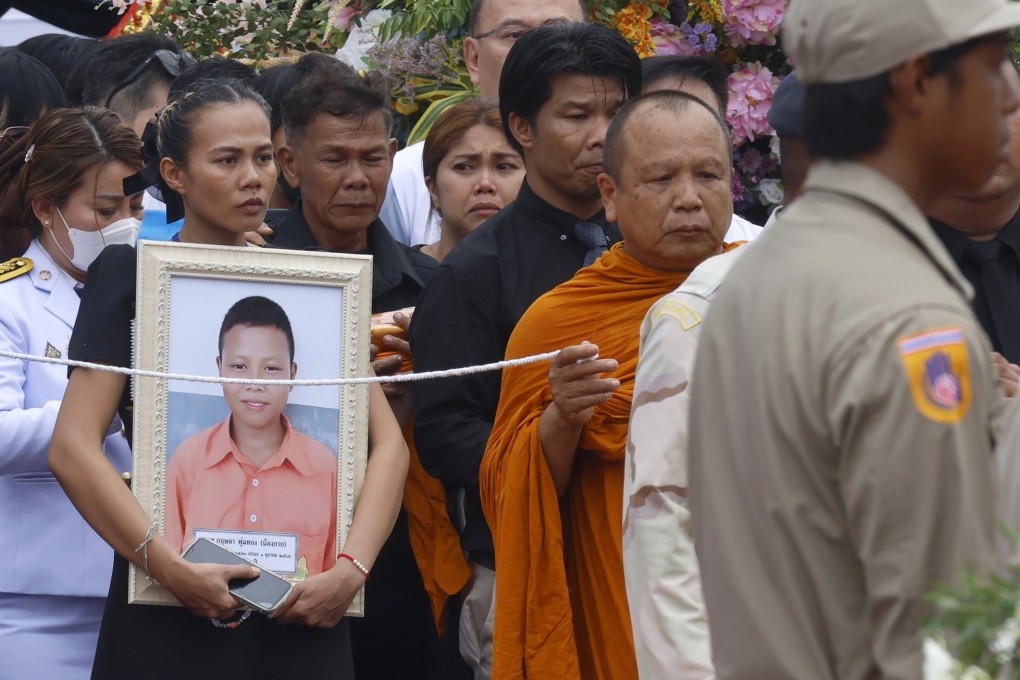 A mother mourns as she carries her son’s picture during the royal sponsored mass cremation rite for the victims of a Thai bus fire, at Uthai Thani province, Thailand on Tuesday. Photo:  EPA-EFE