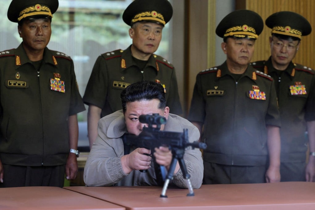 North Korean leader Kim Jong-un (centre) fires a sniper rifle at an undisclosed location in North Korea. Photo: KCNA via Reuters