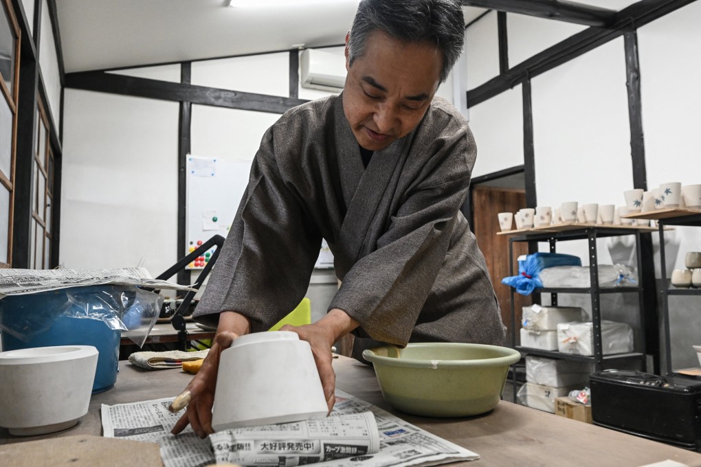 Japanese potter Kosai Yamane shows how to use a pottery mould at his studio in Hatsukaichi, Hiroshima prefecture, Japan, which for more than 100 years has produced ceramics. The market for traditional Japanese art, crafts and design in their domestic market has plunged over the last 30 years. Photo: AFP