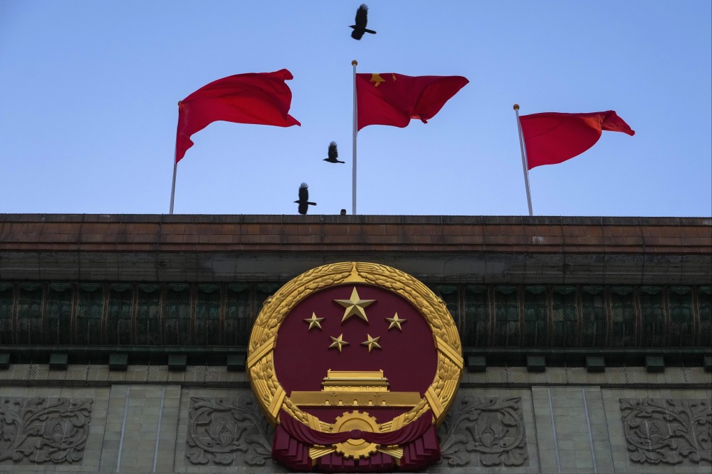 The Chinese national emblem and flags at the Great Hall of the People in Beijing. Recent weeks have signalled that Beijing has prioritised economic recovery and is willing to take more than incremental measures to achieve that goal. Photo: AP