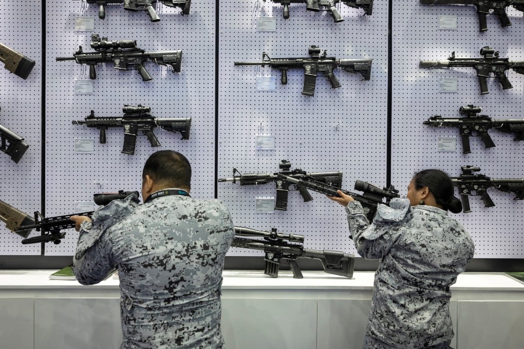 Philippine navy personnel check rifles on display at an arms fair in Pasay City, Metro Manila, last month. Photo: Reuters