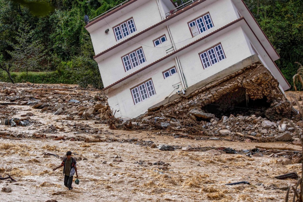 A man wades through the waters of monsoon flooding in Roshi village of Nepal’s Kavre district on September 30. Photo: AFP